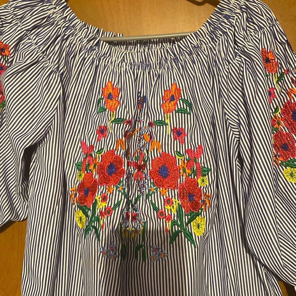 White and blue striped dress with floral print, medium size.